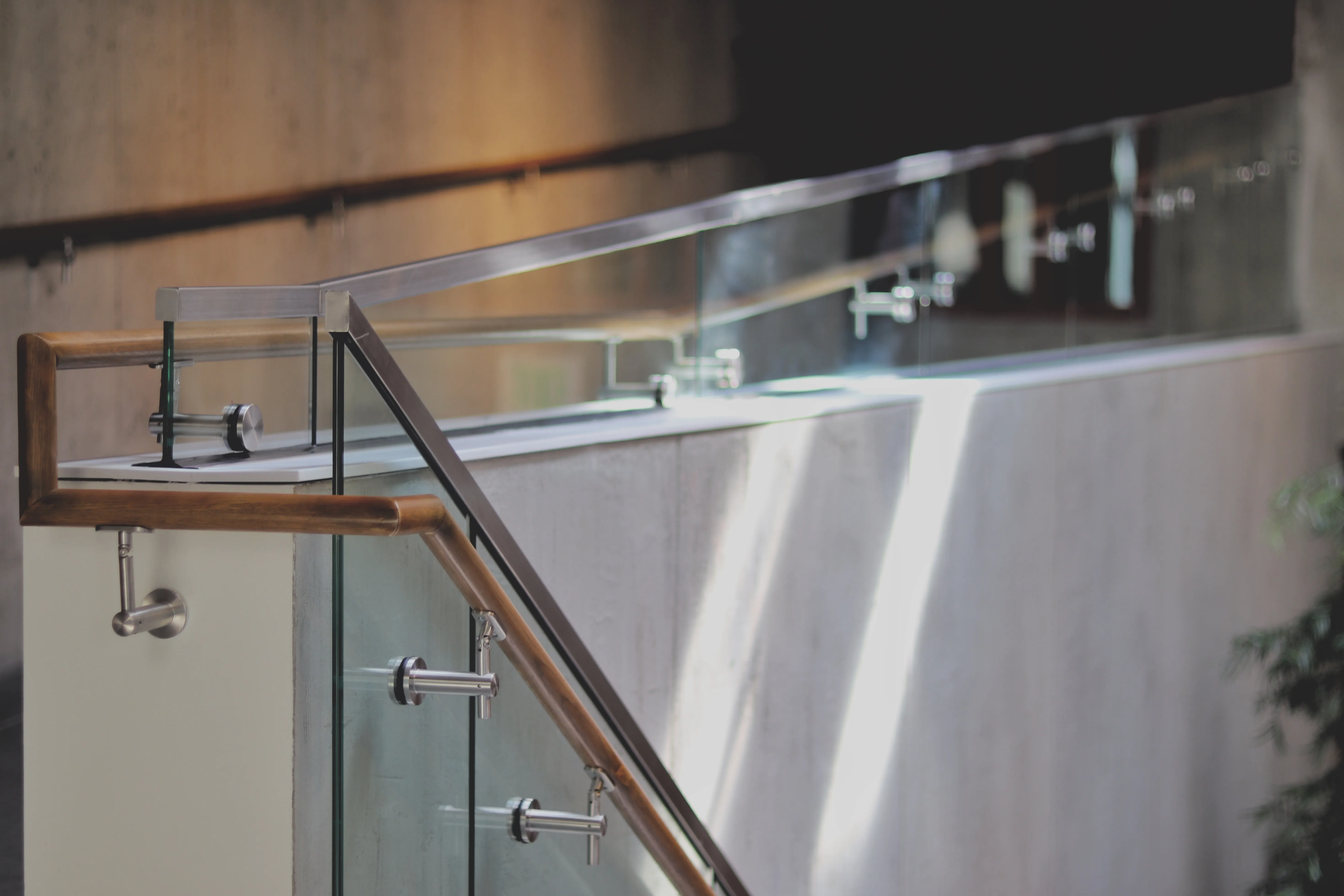 Wood, glass and steel railing on a concrete wall